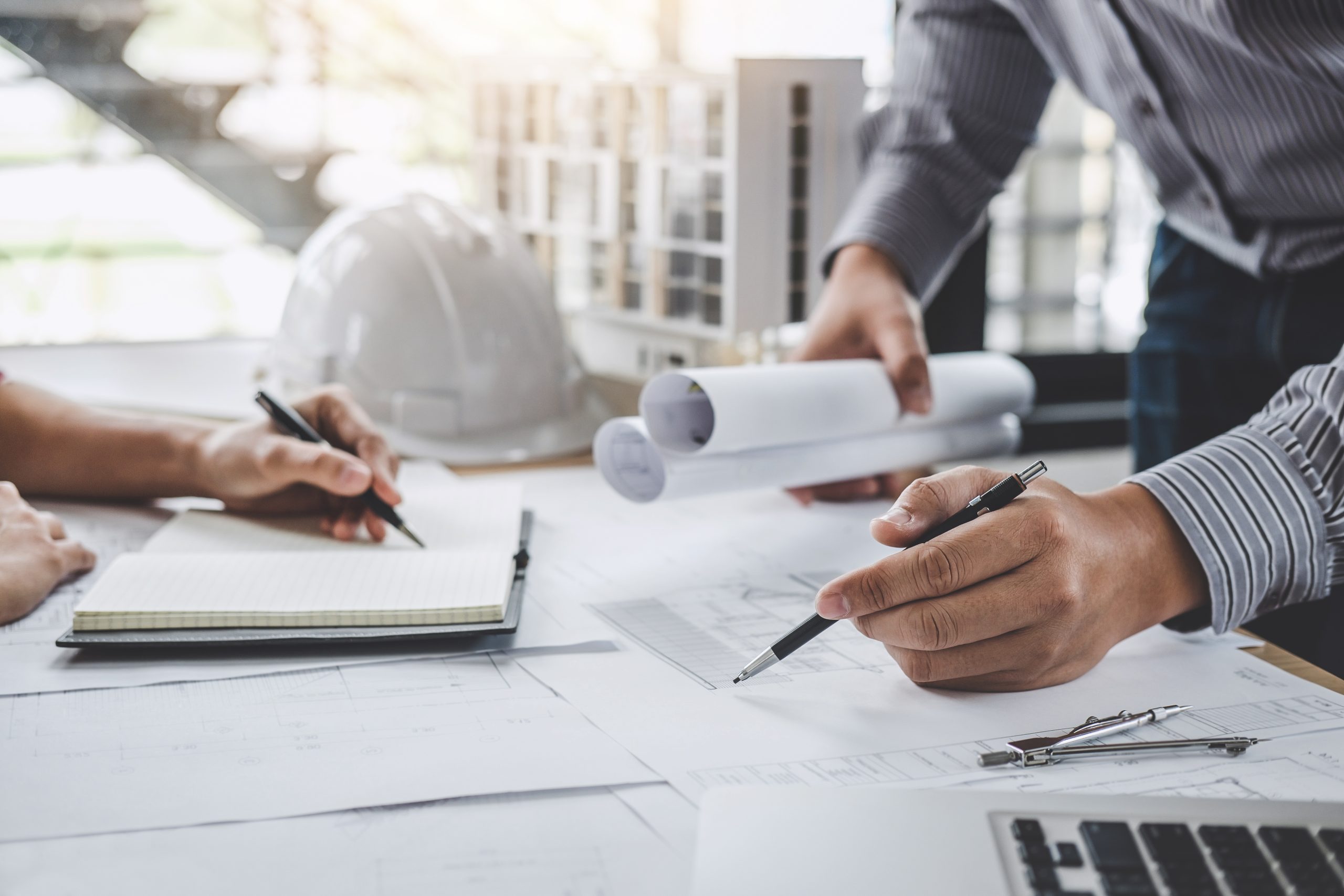 Construction and structure concept of Engineer or architect meeting for project working with partner and engineering tools on model building and blueprint in working site.